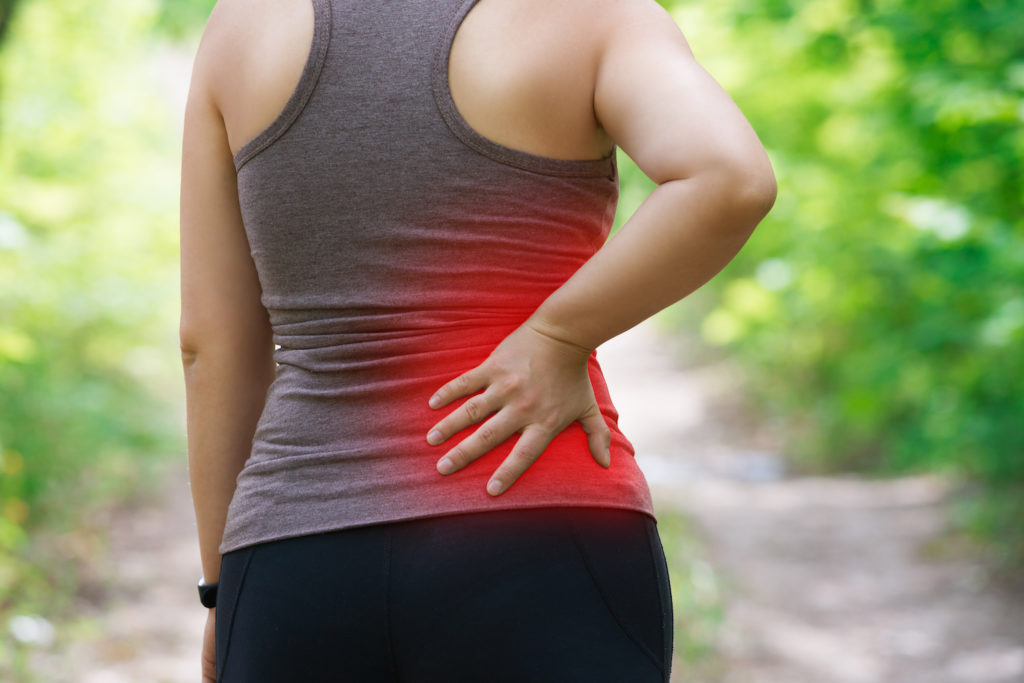 woman suffer from sciatica pain while having a walk