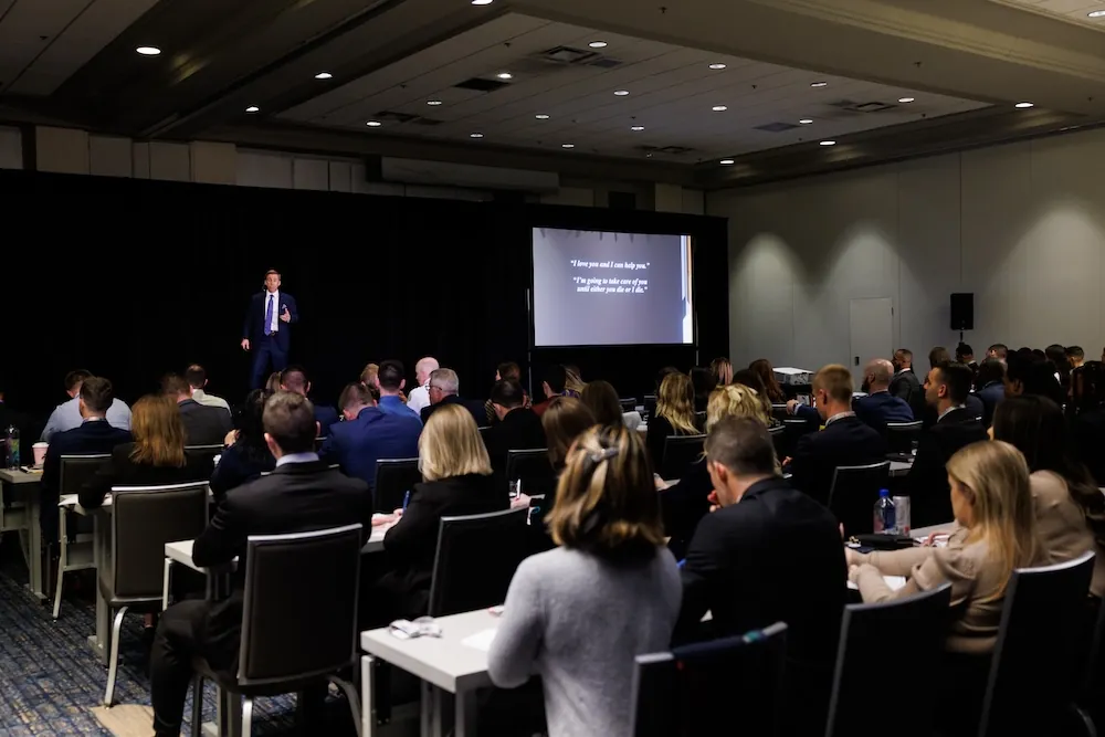 group of people listening to Dr. Sanders